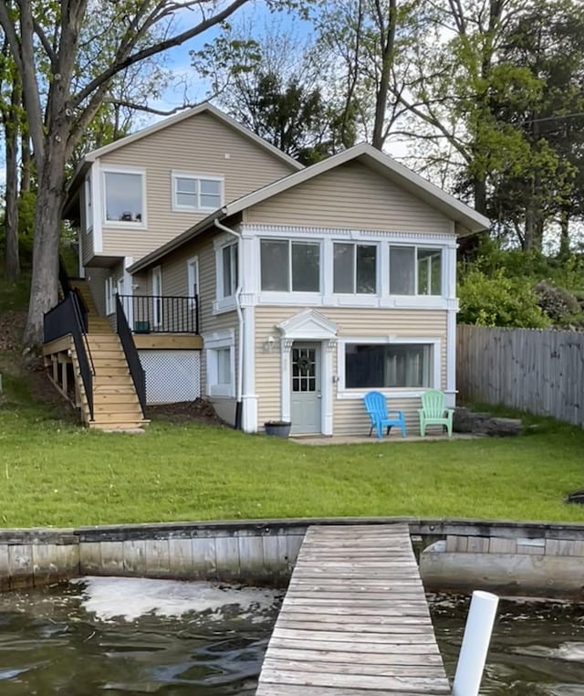 rear view of property with stairway and a deck