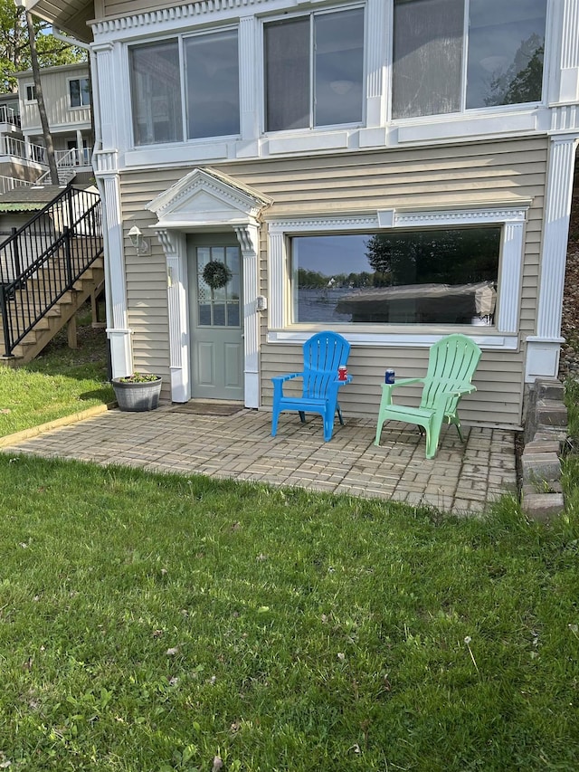 property entrance with a patio and a yard