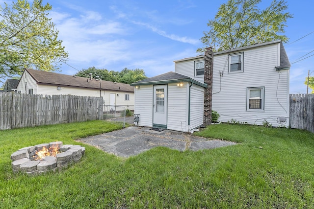 25949 Southwestern Hwy, Redford, MI 48239 - rear view of house with a patio area, an outdoor fire pit, a chimney, and an outdoor structure