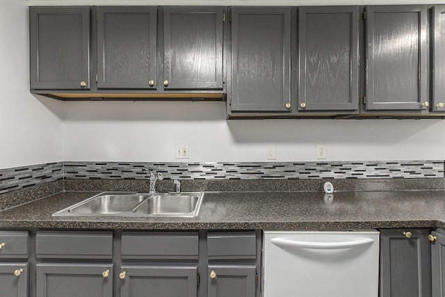25949 Southwestern Hwy, Redford, MI 48239 - kitchen featuring white dishwasher, a sink, gray cabinets, tasteful backsplash, and dark countertops