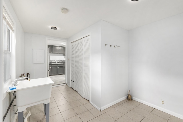 25949 Southwestern Hwy, Redford, MI 48239 - bathroom with tile patterned floors, a freestanding bath, baseboards, and a sink