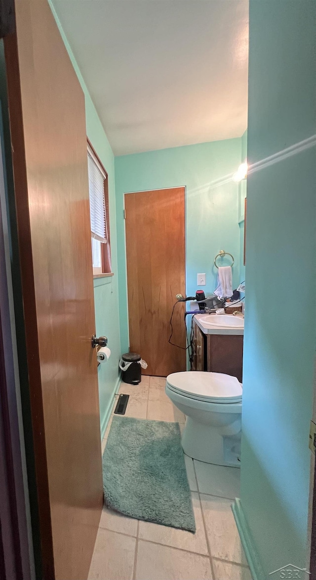 1441 Dover Pl, Saginaw, MI 48638 - half bathroom featuring toilet, vanity, and tile patterned flooring