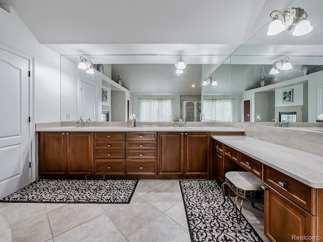 4575 Forest Edge Ln, West Bloomfield, MI 48323 - full bath with double vanity, tile patterned floors, a shower with door, and a fireplace