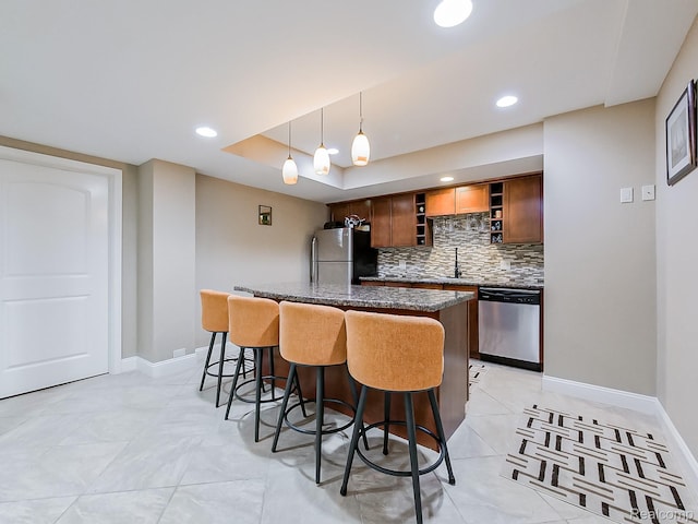4575 Forest Edge Ln, West Bloomfield, MI 48323 - kitchen with appliances with stainless steel finishes, a breakfast bar, a kitchen island, tasteful backsplash, and open shelves