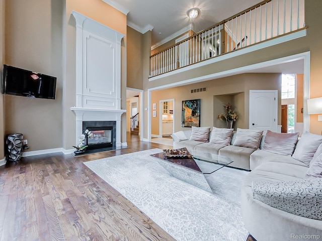 4575 Forest Edge Ln, West Bloomfield, MI 48323 - living area with a high ceiling, wood finished floors, baseboards, ornamental molding, and a fireplace