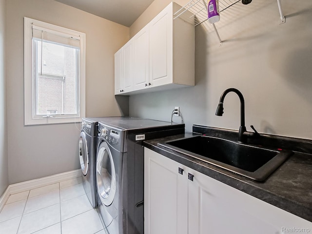 4575 Forest Edge Ln, West Bloomfield, MI 48323 - laundry area featuring cabinet space, washing machine and dryer, baseboards, and light tile patterned floors