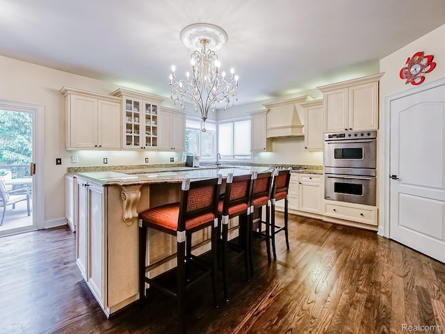 4575 Forest Edge Ln, West Bloomfield, MI 48323 - kitchen featuring stainless steel double oven, a chandelier, dark wood-style flooring, and custom range hood