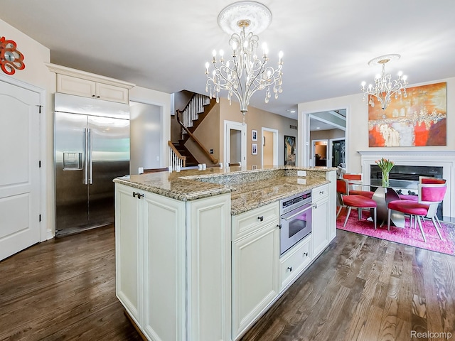 4575 Forest Edge Ln, West Bloomfield, MI 48323 - kitchen featuring appliances with stainless steel finishes, a chandelier, dark wood finished floors, and pendant lighting