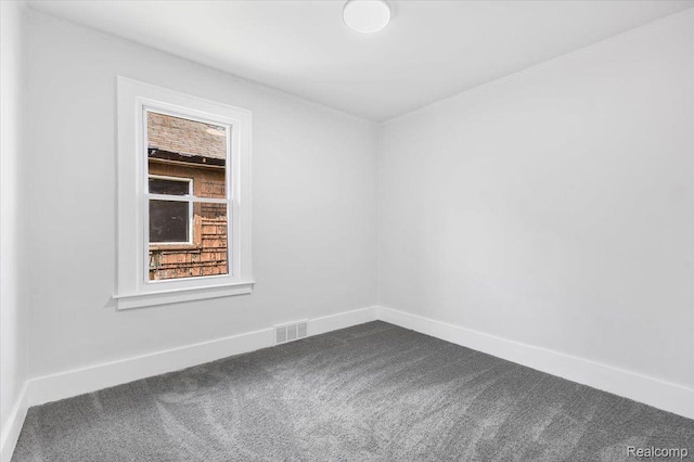 12242 Washburn St, Detroit, MI 48204 - empty room with dark carpet, healthy amount of natural light, baseboards, and ornamental molding