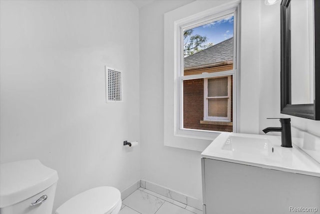 12242 Washburn St, Detroit, MI 48204 - bathroom with toilet, baseboards, vanity, and marble finish flooring