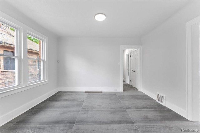 12242 Washburn St, Detroit, MI 48204 - empty room with baseboards and concrete flooring