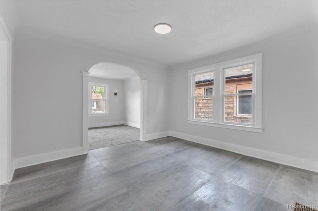 12242 Washburn St, Detroit, MI 48204 - spare room featuring arched walkways and baseboards