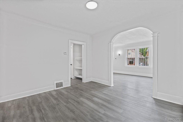 12242 Washburn St, Detroit, MI 48204 - spare room featuring arched walkways, wood finished floors, and baseboards
