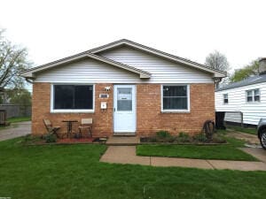 26048 Clancy St, Roseville, MI 48066 - view of front of house with brick siding and a front yard