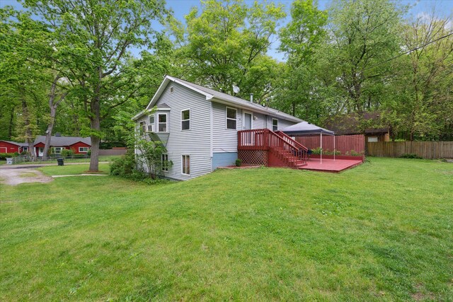 6544 Woodland Rd, Whitmore Lake, MI 48189 - rear view of house featuring a wooden deck