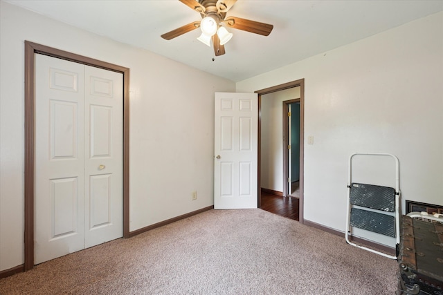 6544 Woodland Rd, Whitmore Lake, MI 48189 - unfurnished bedroom with carpet, baseboards, a closet, and a ceiling fan