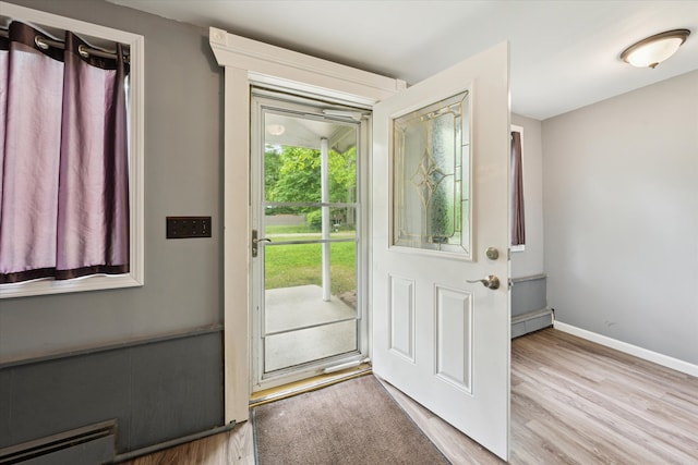 6544 Woodland Rd, Whitmore Lake, MI 48189 - entrance foyer featuring a baseboard radiator, wood finished floors, and baseboards