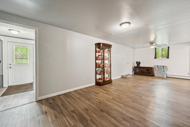 6544 Woodland Rd, Whitmore Lake, MI 48189 - unfurnished living room with a ceiling fan, wood finished floors, and baseboards