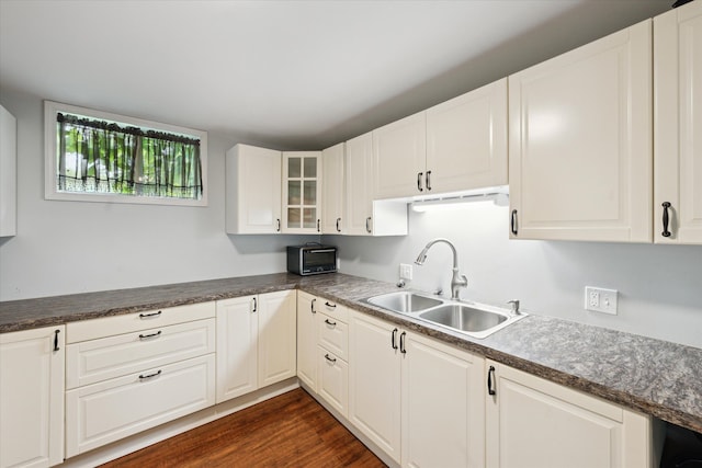 6544 Woodland Rd, Whitmore Lake, MI 48189 - kitchen with a sink, glass insert cabinets, white cabinets, dark wood-style flooring, and dark countertops