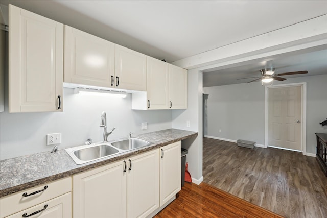 6544 Woodland Rd, Whitmore Lake, MI 48189 - kitchen featuring a sink, dark wood-type flooring, ceiling fan, white cabinets, and baseboards