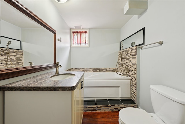 6544 Woodland Rd, Whitmore Lake, MI 48189 - full bathroom with toilet, vanity, a garden tub, and wood finished floors