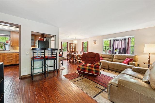 6544 Woodland Rd, Whitmore Lake, MI 48189 - living area featuring a chandelier and dark wood-type flooring