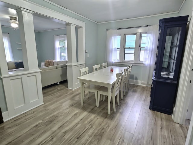 5014 Ford St, Swartz Creek, MI 48473 - dining area featuring decorative columns, light wood-style floors, ornamental molding, and plenty of natural light