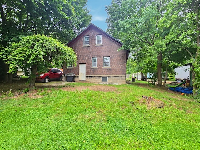 5014 Ford St, Swartz Creek, MI 48473 - back of house with brick siding and a lawn