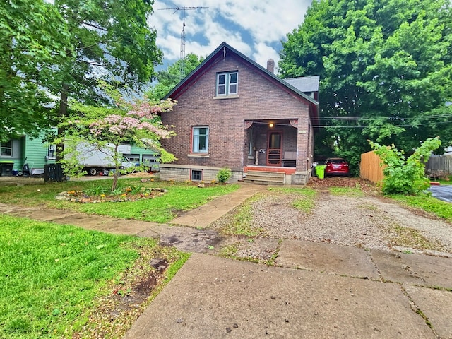 5014 Ford St, Swartz Creek, MI 48473 - rear view of house featuring brick siding, a chimney, and a porch