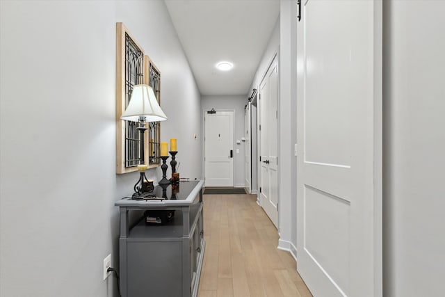 804 N Main St Unit 2C, Rochester, MI 48307 - corridor featuring a barn door and light wood-type flooring