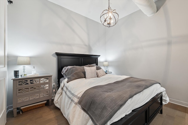 804 N Main St Unit 2C, Rochester, MI 48307 - bedroom with wood finished floors, a chandelier, and baseboards
