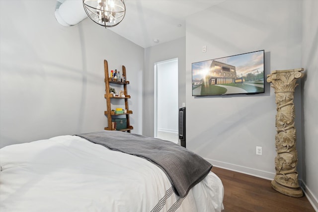 804 N Main St Unit 2C, Rochester, MI 48307 - bedroom with wood finished floors, baseboards, and a chandelier