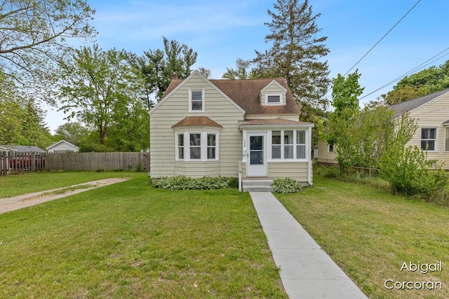 124 Janet St SE, Wyoming, MI 49548 - view of front facade featuring a shingled roof and a chimney