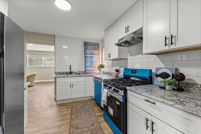 8903 Appleton, Redford, MI 48239 - kitchen with under cabinet range hood, appliances with stainless steel finishes, backsplash, light wood finished floors, and white cabinetry
