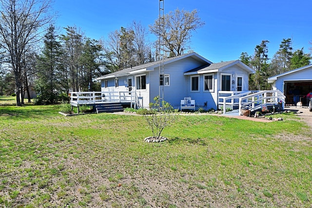 2741 E M 72, Grayling, MI 49738 - back of property with a deck, a yard, and a garage