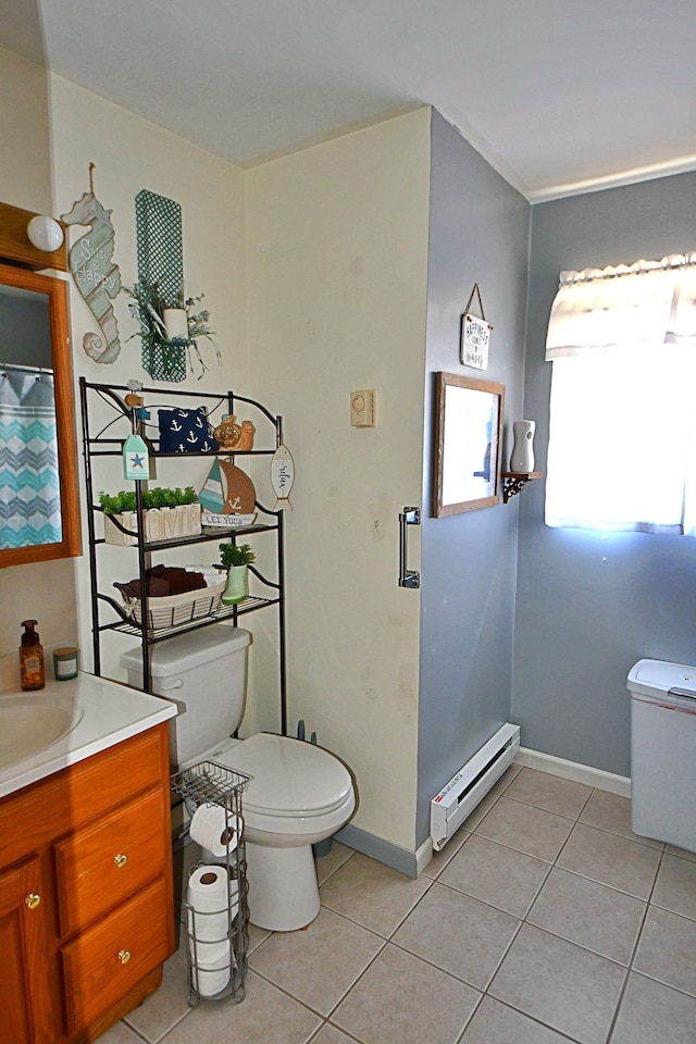 2741 E M 72, Grayling, MI 49738 - bathroom featuring a baseboard radiator, toilet, tile patterned flooring, vanity, and baseboards