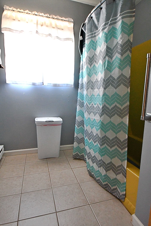 2741 E M 72, Grayling, MI 49738 - bathroom with baseboards, tile patterned floors, curtained shower, and toilet
