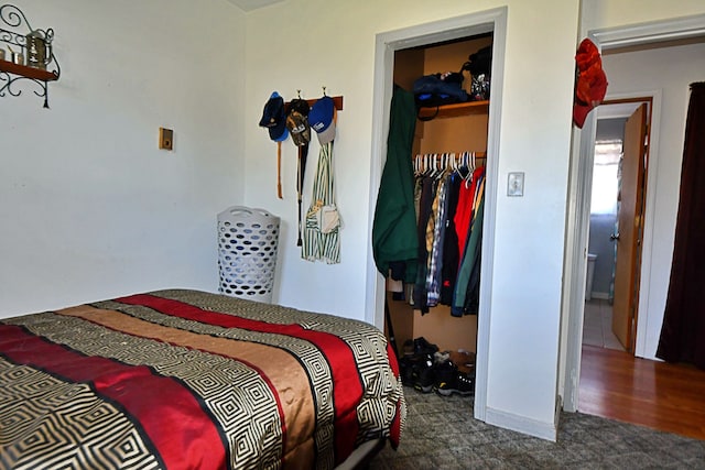 2741 E M 72, Grayling, MI 49738 - carpeted bedroom featuring a closet, a walk in closet, and baseboards