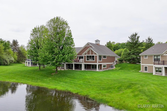 7708 Stations Dr SW, Byron Center, MI 49315 - back of property with a lawn and a deck with water view