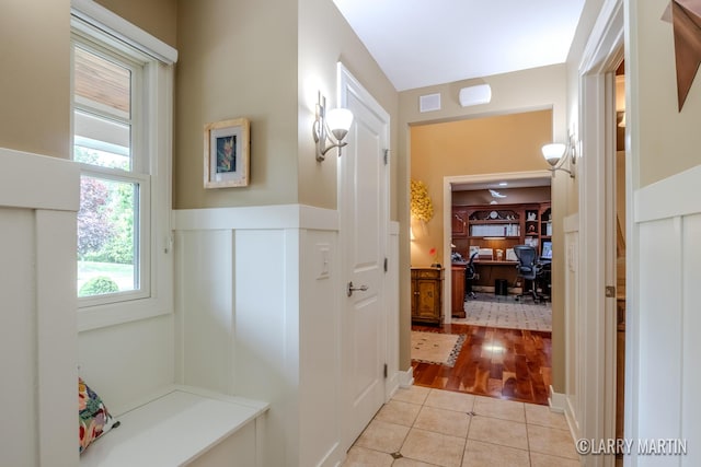 7708 Stations Dr SW, Byron Center, MI 49315 - hallway with an office area, light tile patterned flooring, healthy amount of natural light, and a wainscoted wall