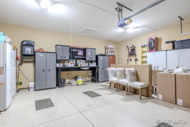 7708 Stations Dr SW, Byron Center, MI 49315 - garage with a garage door opener and freestanding refrigerator