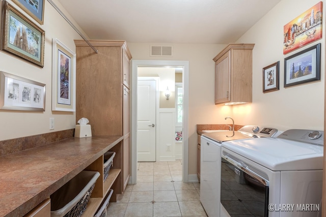 7708 Stations Dr SW, Byron Center, MI 49315 - washroom featuring washing machine and dryer, light tile patterned flooring, and cabinet space