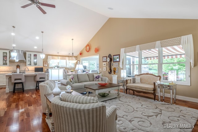 7708 Stations Dr SW, Byron Center, MI 49315 - living room with high vaulted ceiling, a ceiling fan, and wood finished floors