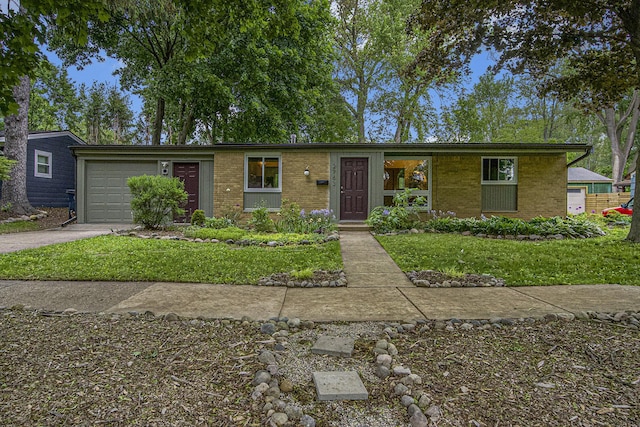 2753 Cumberland Ave, Ann Arbor, MI 48104 - single story home with brick siding, an attached garage, driveway, and a front yard