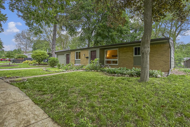 2753 Cumberland Ave, Ann Arbor, MI 48104 - ranch-style house featuring a garage, a front lawn, and brick siding