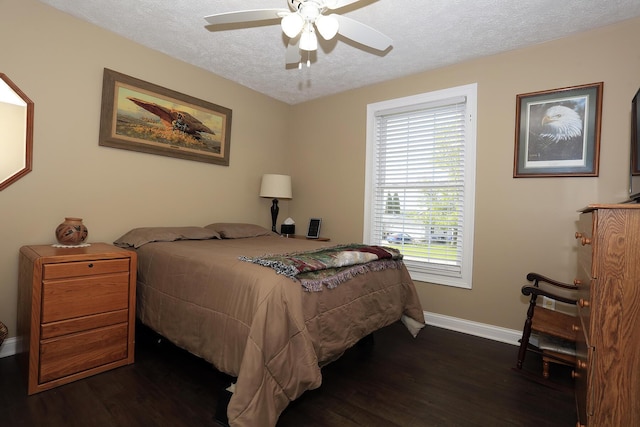113 Davis Dr, Brooklyn, MI 49230 - bedroom with baseboards, dark wood-type flooring, a textured ceiling, and a ceiling fan