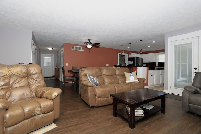 113 Davis Dr, Brooklyn, MI 49230 - living area featuring wood finished floors, a ceiling fan, healthy amount of natural light, baseboards, and a textured ceiling