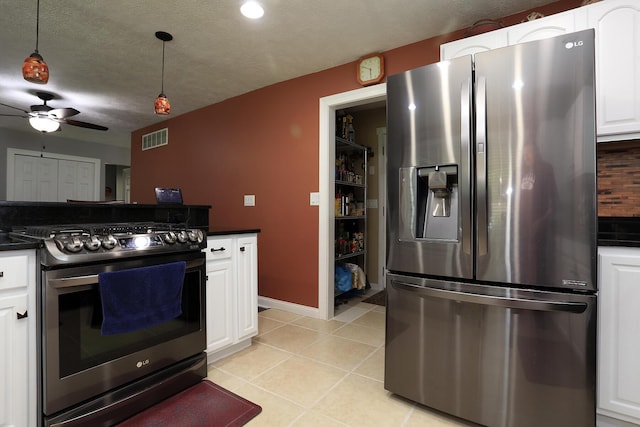 113 Davis Dr, Brooklyn, MI 49230 - kitchen with appliances with stainless steel finishes, dark countertops, white cabinetry, ceiling fan, and light tile patterned floors