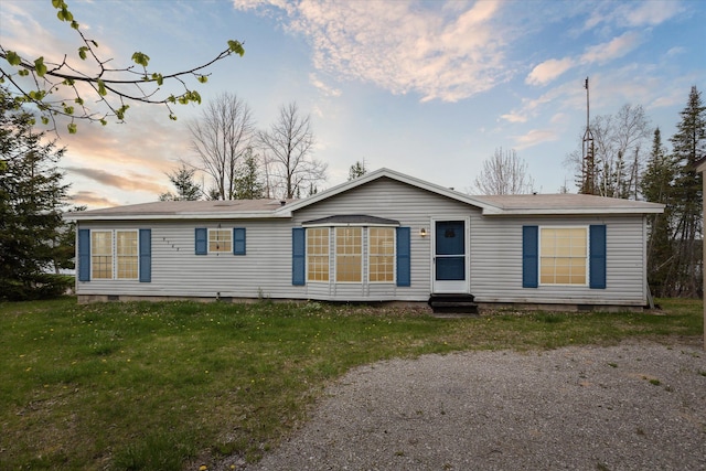 9168 Clewley Rd, Lachine, MI 49753 - back of property at dusk featuring crawl space, entry steps, and a yard