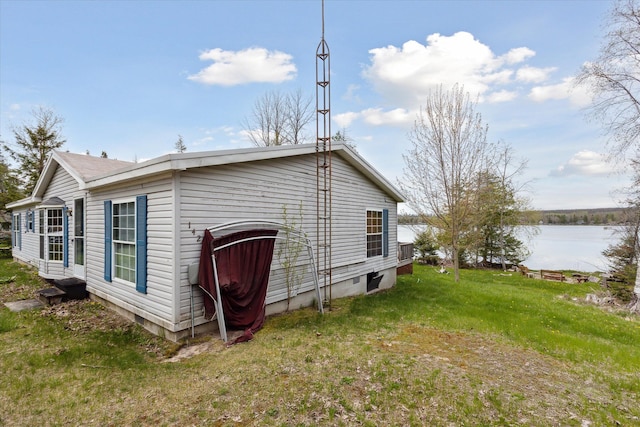 9168 Clewley Rd, Lachine, MI 49753 - view of home's exterior with a water view and a yard